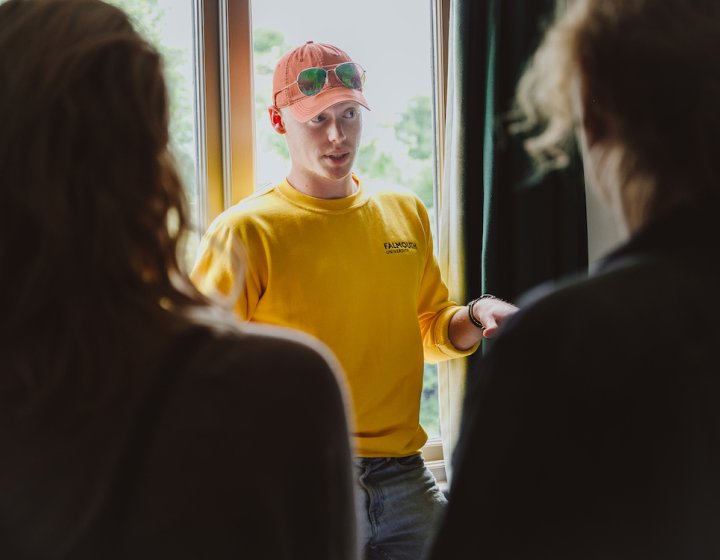 Student ambassador stood in front of window talking to group.