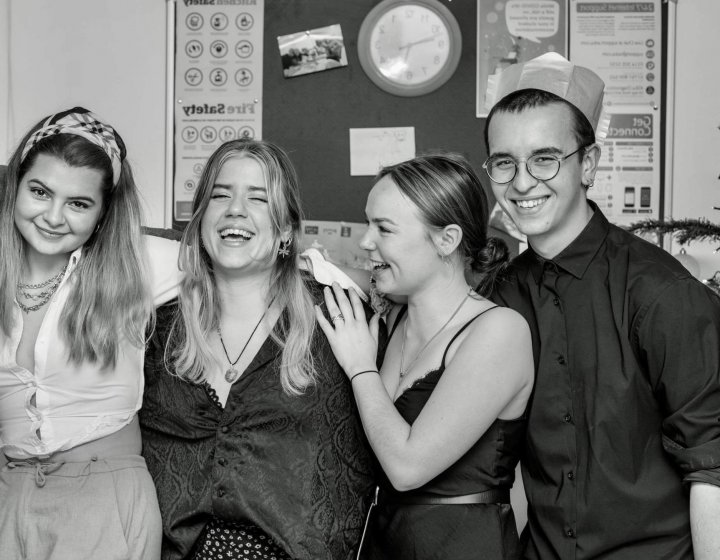 International student Orestis posing with friends at a Christmas party