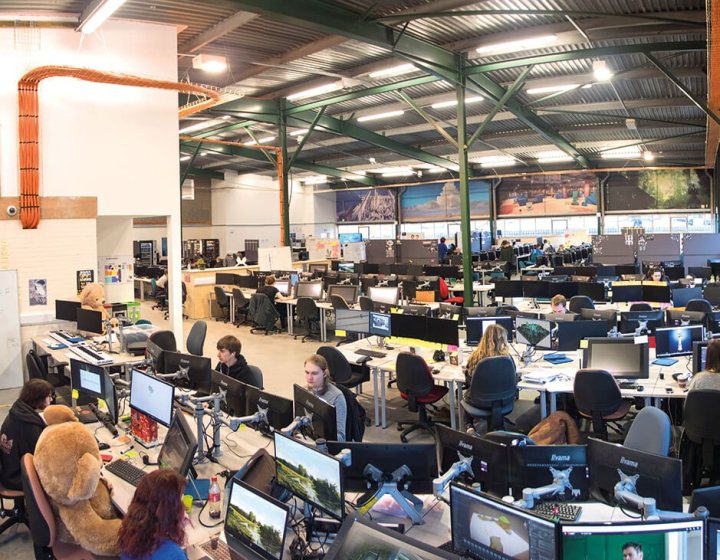 View of busy games academy, students working on computers