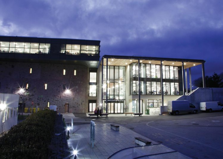 Penryn Campus glass building lit up at night