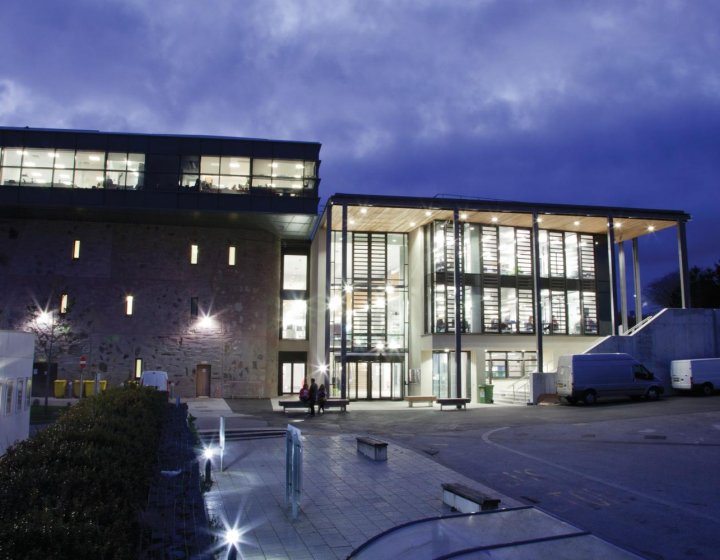 Penryn Campus glass building lit up at night