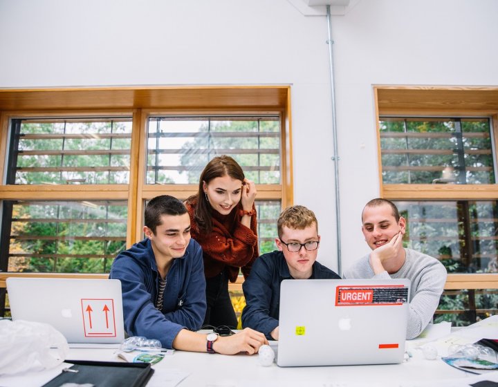 Students looking at a computer together