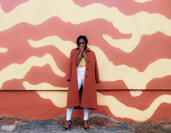 Student posing in a red coat for fashion marketing photo