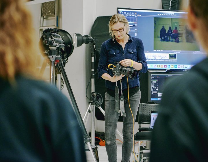 Falmouth Photography lecturer using camera equipment in a studio