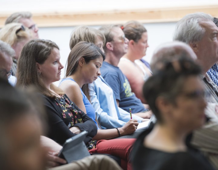 Men and women seated in a crowd