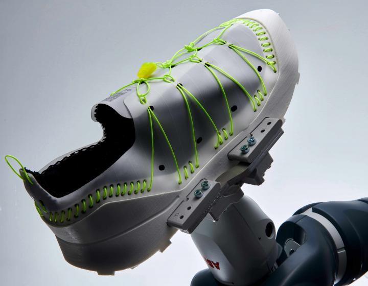 Max's shoe is held up by a robot arm