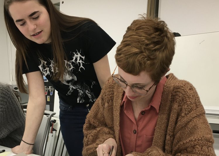 Student Hollie Milne making a model with fellow student looking on