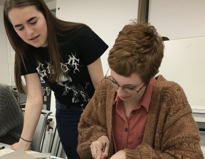 Student Hollie Milne making a model with fellow student looking on