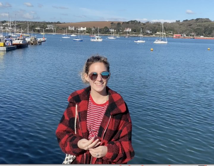 Picture of Amy Wood, student content creator and Ambassador, by the sea in Falmouth.