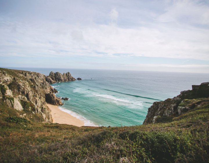 on a cliff top overlooking the beach and sea