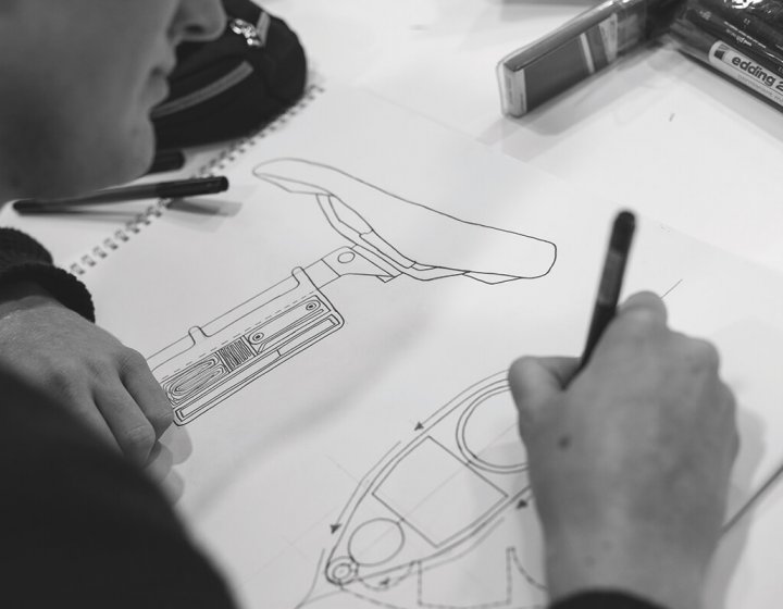 Student drawing design for a bike seat.