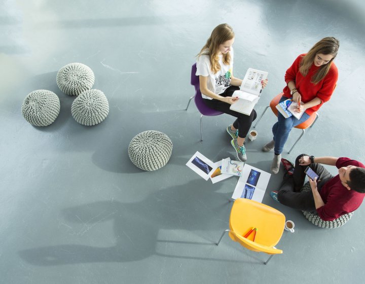 Falmouth University Business students sitting on chairs, having a discussion