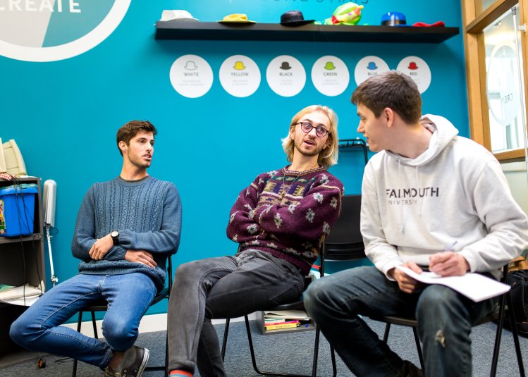 Students sat on chairs and having a discussion.