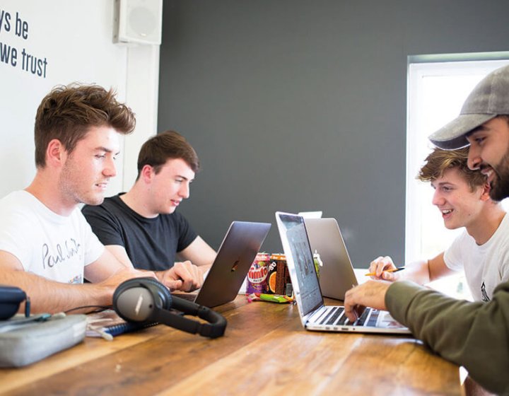 Business students working on laptops