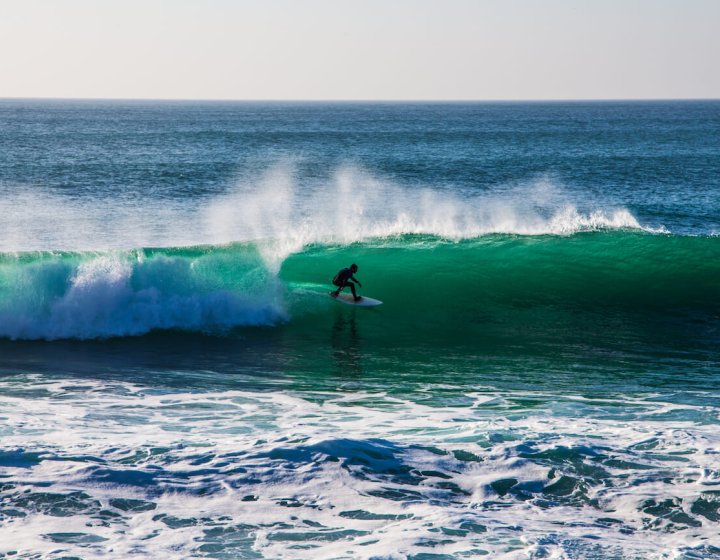 Surfer inside the tube of a wave