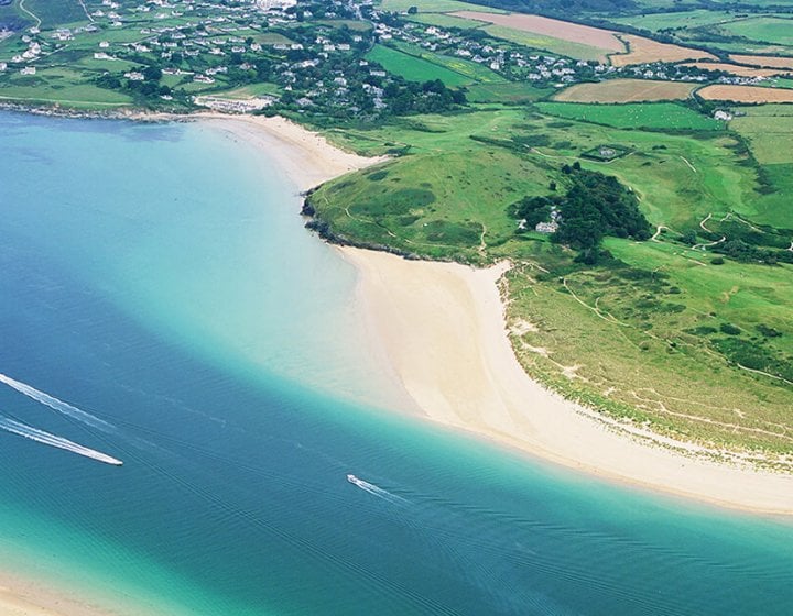 Aerial view of an estuary with sandy beaches and fields