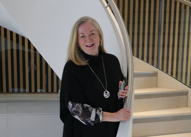 Professor Anne Carlisle in front of a staircase