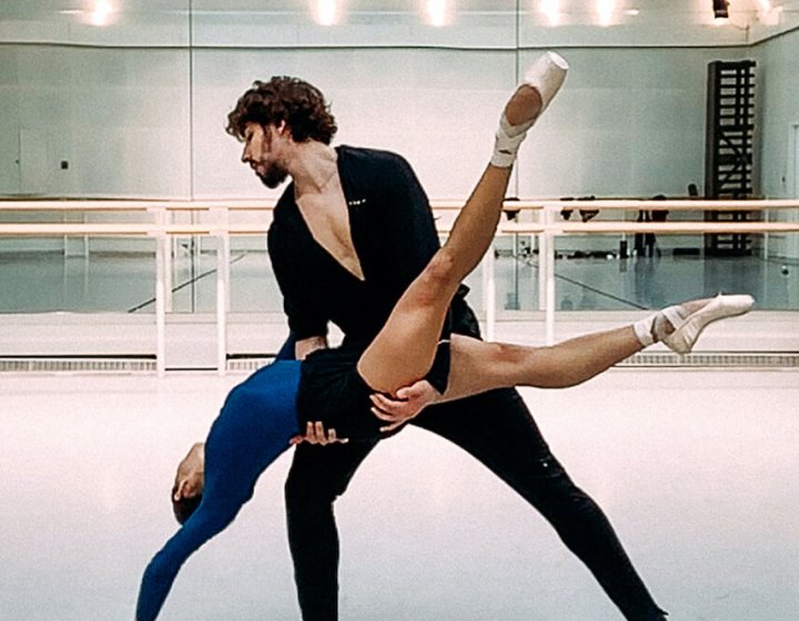 Two dancers from the Royal Opera House performing in a studio