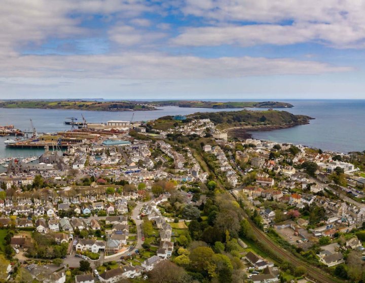 View from above of Falmouth, houses, coastline, sea and clouds.