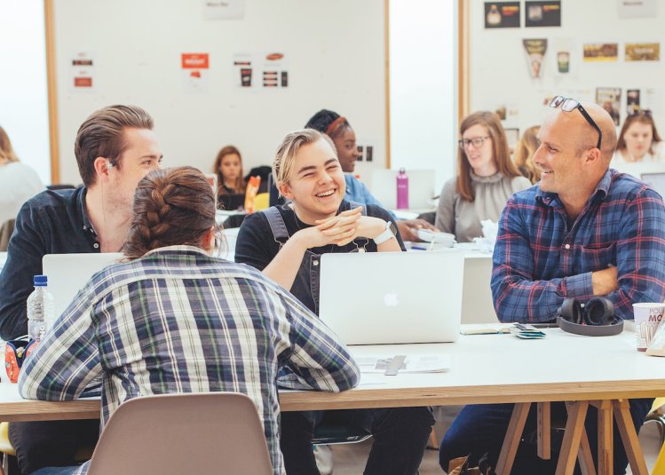 Students and a teacher in a graphic design studio
