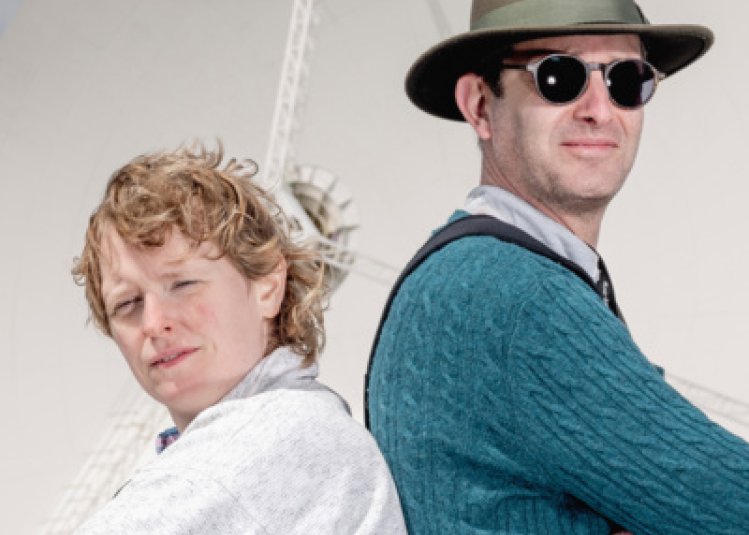 Two people stood with their backs to one another