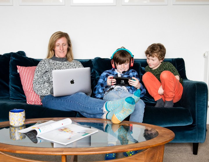 A family sat on a sofa