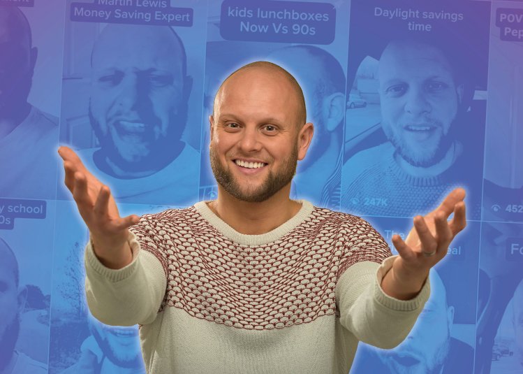 The comedian, Tom Glover, posing for a photo against a blue and purple background