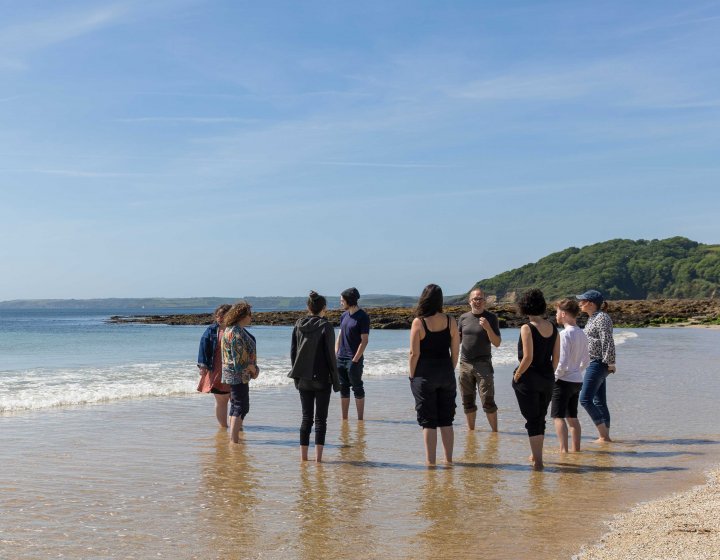 BA Creative Writing (Online) students on the beach with Wyl Menmuir