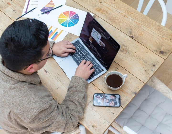 Person sat at a desk working on a laptop