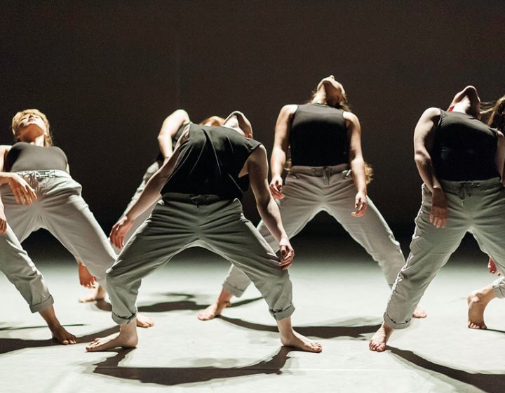 Dance students arching bodies backwards