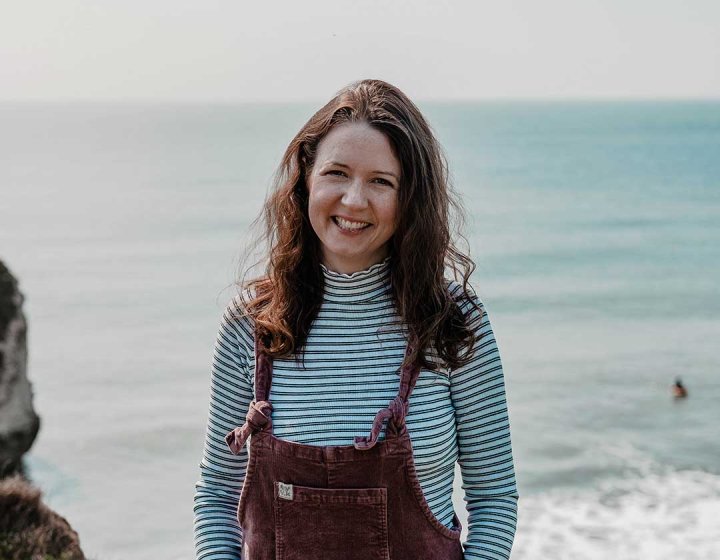 Graduate Emma stood on a cliff on the Isle of Wight