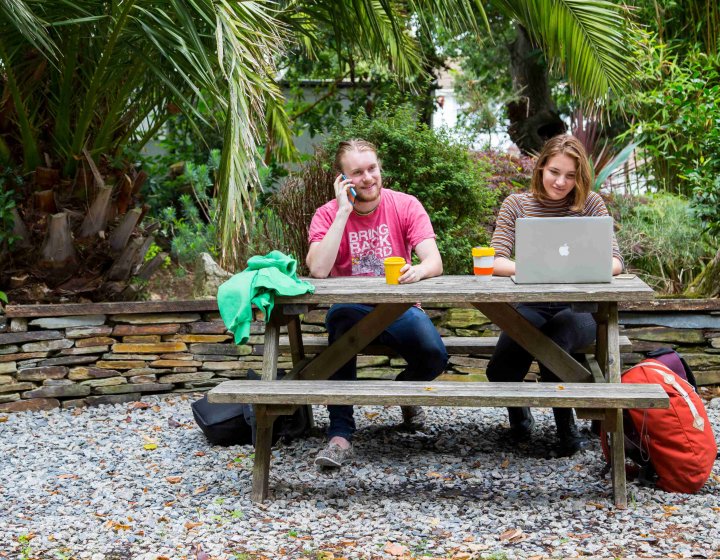 A man and a woman sitting on a bench