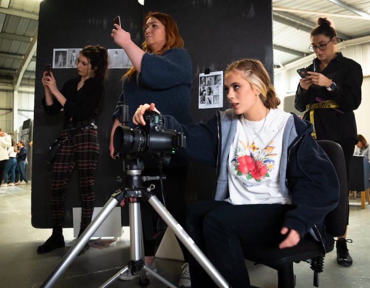 Students with cameras in a studio