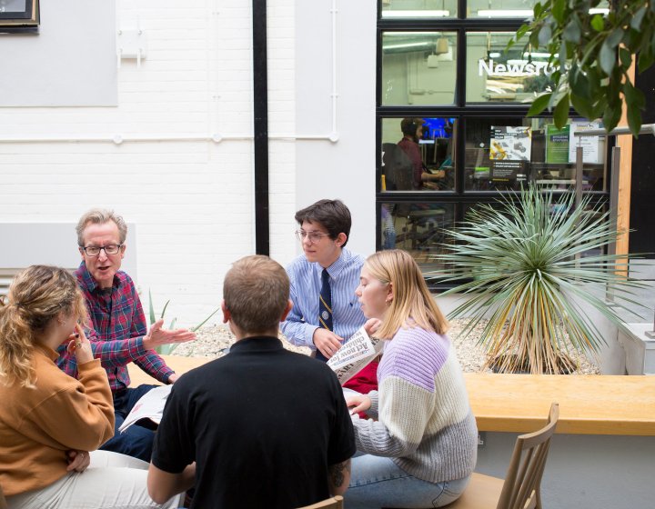 Journalism students sitting in a circle