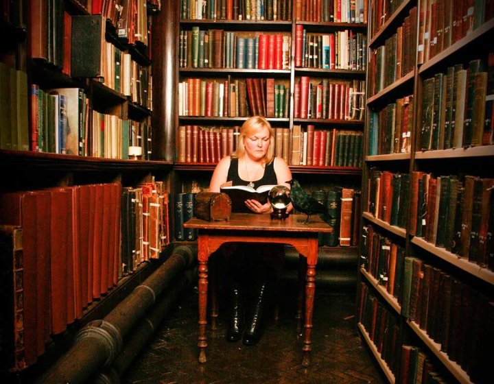 Author Lynn Huggins-Cooper sat in a library reading a book