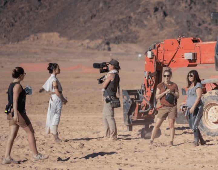 Four women shooting a documentary about the making of Star Wars on a desert-like set