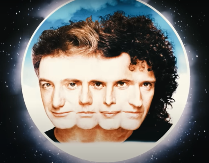 White moon on black starry background with the faces of each member of Queen overlapping in the centre.