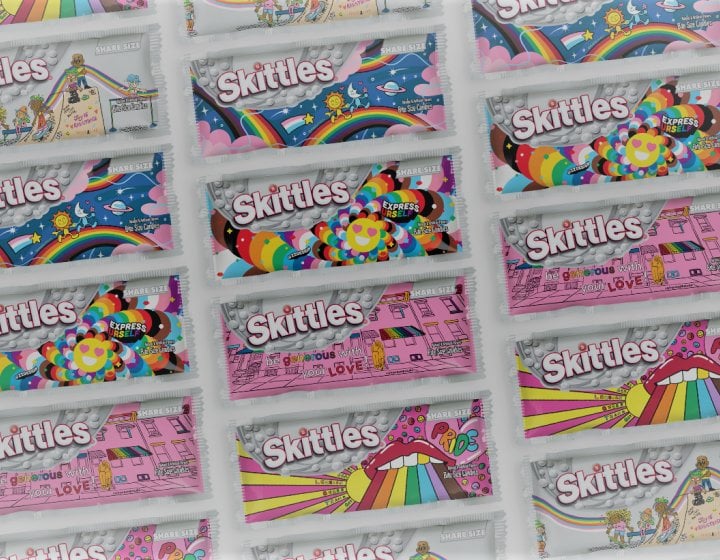 Screenshot of Skittles' Pride webpage banner featuring rainbow-less packets of Skittles.