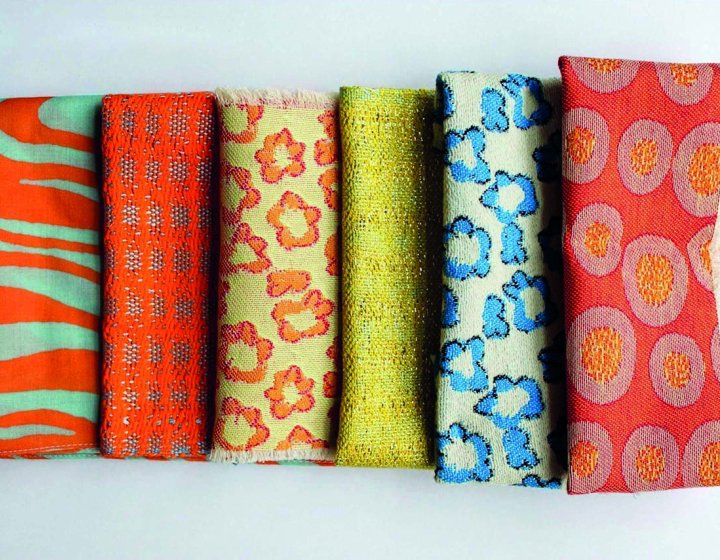 Six pieces of fabric lined up together with different patterns and textures