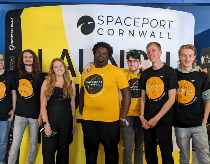 A group of students stand shoulder to shoulder wearing 'Spaceport Cornwall' tshirts