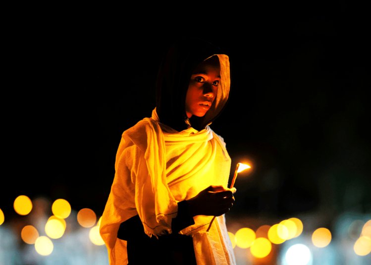 A boy holding a candle at Ethiopia