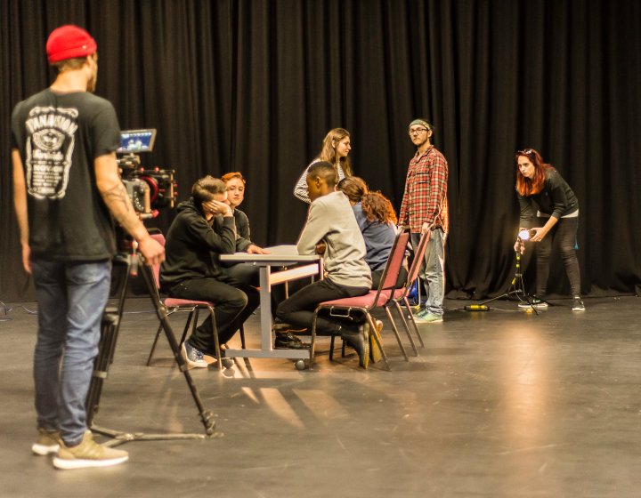 Photo of actors in rehearsal on a stage