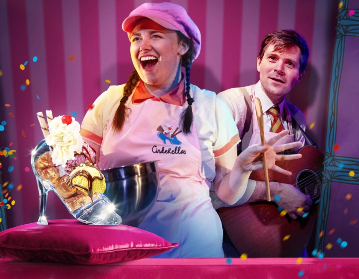 A performers in an ice cream booth with an ice cream sundae in a glass slipper in the front of the image