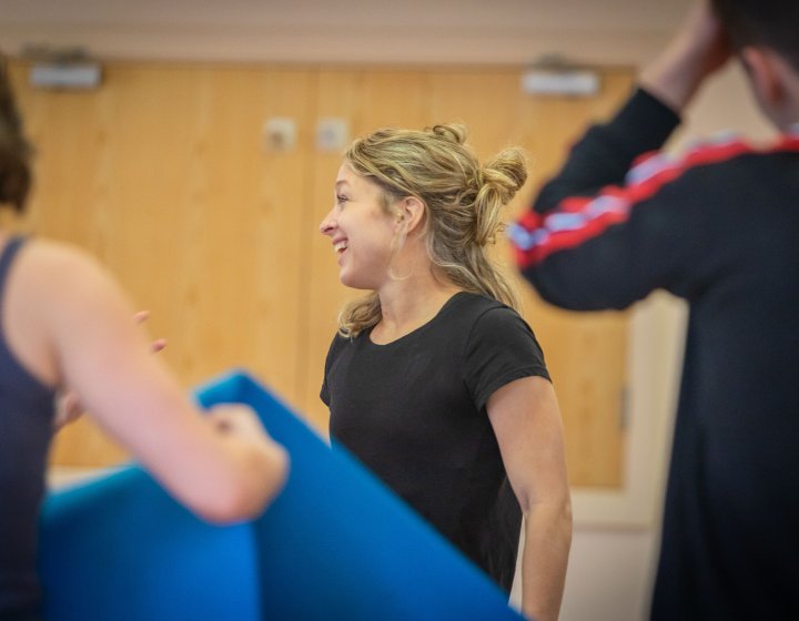 A small group of people looking away from the camera after completing a dance fitness class