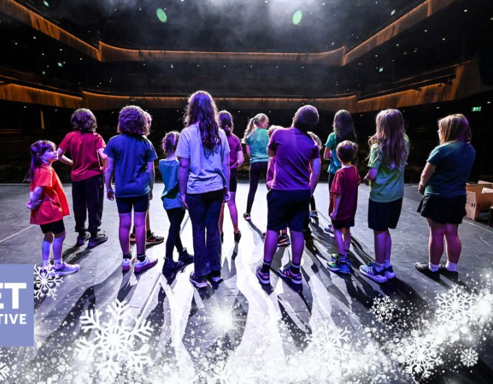 A group of young performers on the Hall for Cornwall Stage with a winter motif on the image