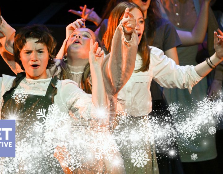 A group of young performers on the Hall for Cornwall Stage with a winter motif on the image