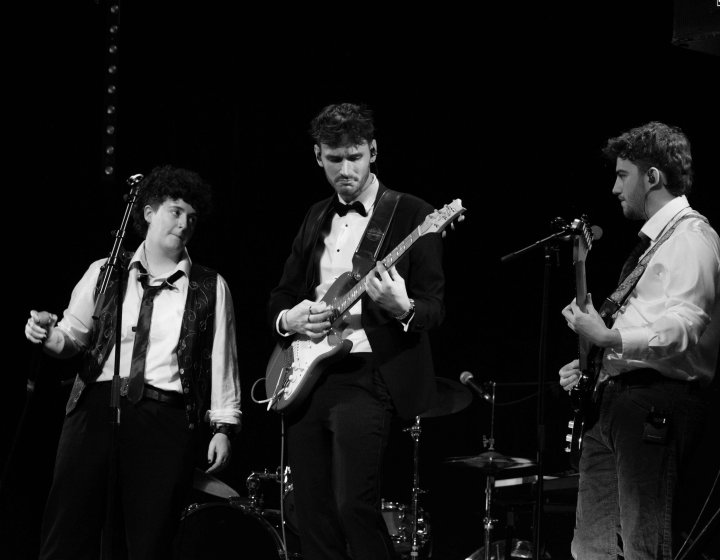 Black and white image of three musicians with the bass player in the centre