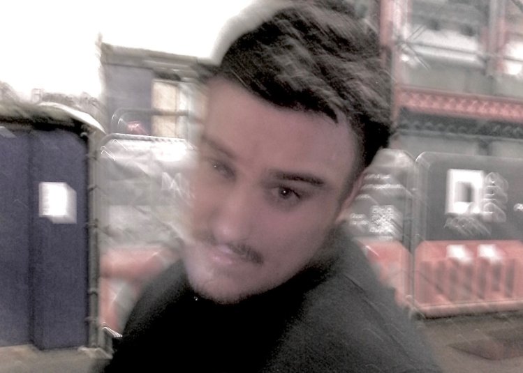 A blurred headshot of Joel Yarwood