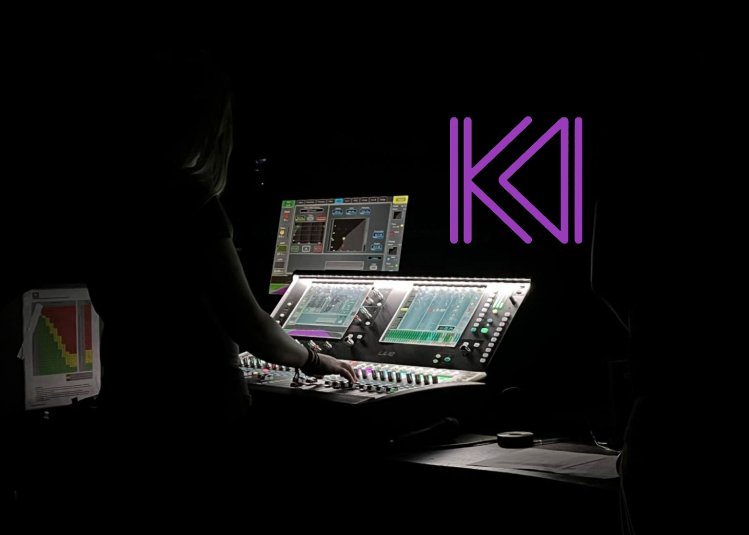 A person mixing a live band with a mixing desk in view