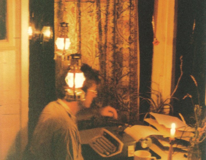 An image of Nick Darke writing at a desk